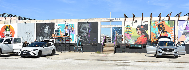 Artists work on the outside wall during Essex Paint Jam Volume 4 on Saturday, Jan. 6, 2024, at Essex Modern City in San Antonio.